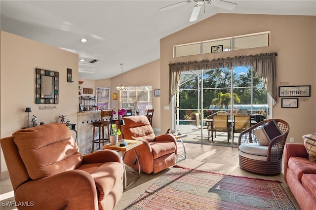 living room featuring lofted ceiling, light tile patterned floors, and ceiling fan with notable chandelier