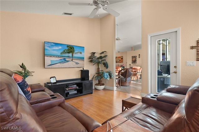 living room with ceiling fan and light hardwood / wood-style flooring