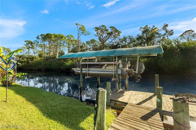 dock area with a lawn and a water view