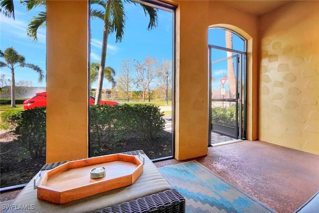 doorway to outside featuring carpet floors