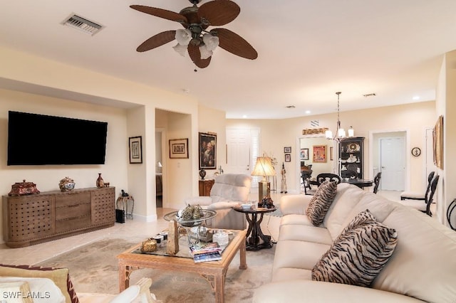 living room with ceiling fan with notable chandelier