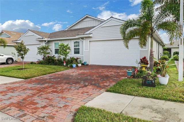 view of front of home with a garage and a front lawn