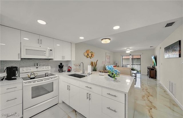 kitchen featuring kitchen peninsula, sink, white cabinets, and white appliances