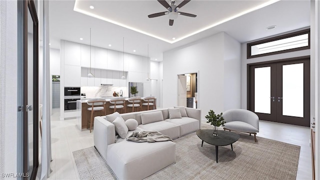 living room with a raised ceiling, ceiling fan, french doors, and sink