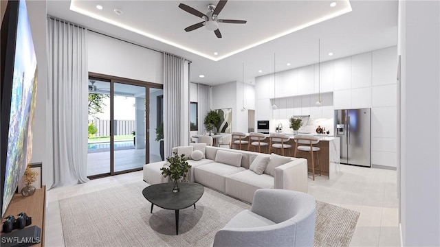 living room featuring ceiling fan, light tile patterned flooring, and a tray ceiling