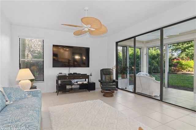 living area with tile patterned flooring and ceiling fan