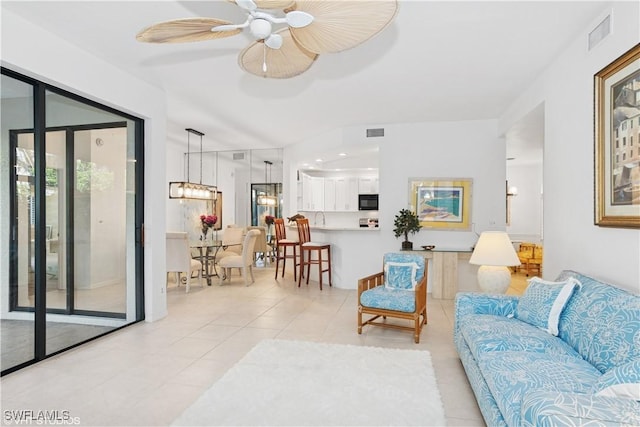 living room featuring ceiling fan, light tile patterned flooring, and visible vents