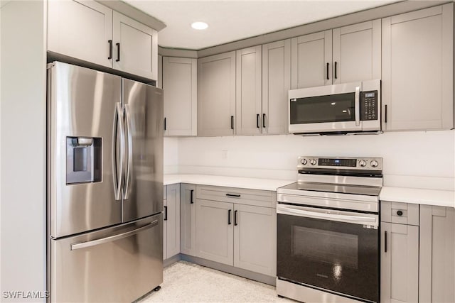 kitchen featuring gray cabinetry and stainless steel appliances