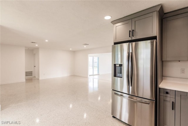 kitchen featuring stainless steel fridge with ice dispenser and gray cabinetry