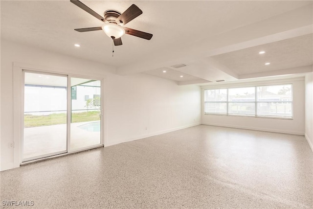 empty room featuring beamed ceiling and ceiling fan