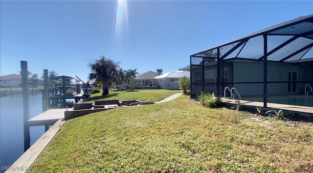 view of yard with a water view and glass enclosure