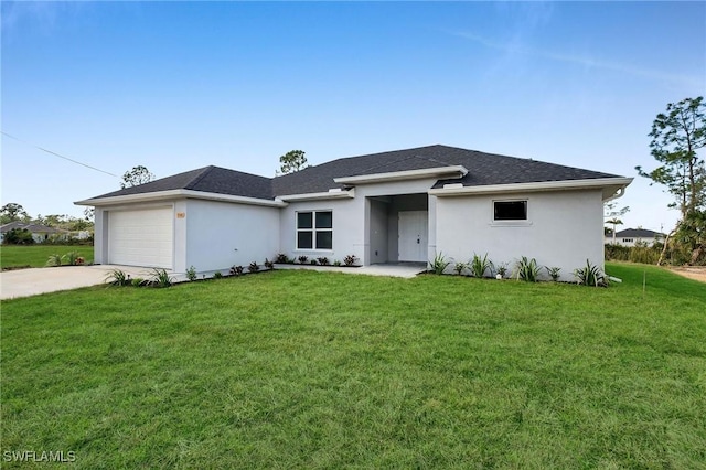 view of front of house with a garage and a front lawn