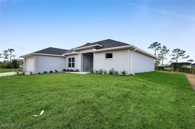 view of front facade featuring a garage and a front lawn