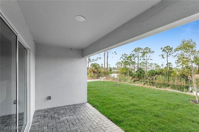 view of yard with a patio area and a water view