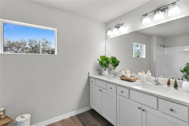 bathroom featuring a shower, hardwood / wood-style floors, and vanity