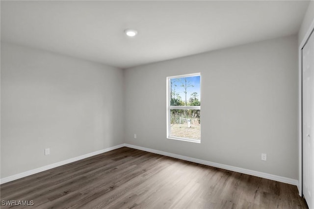 spare room with dark wood-type flooring