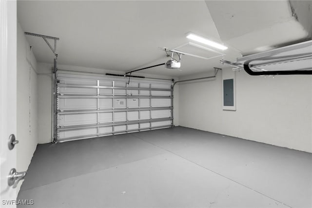 garage with a garage door opener and electric panel