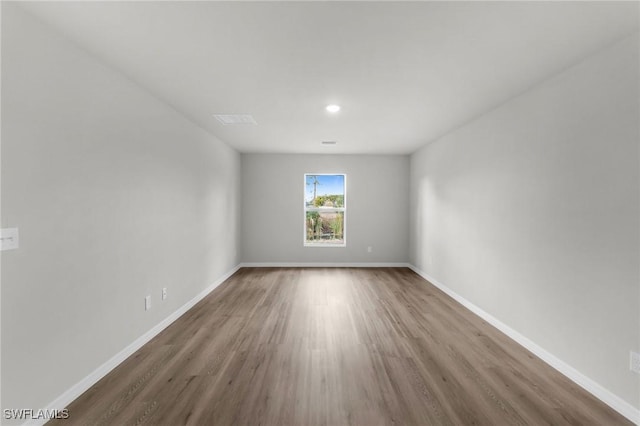 unfurnished room featuring hardwood / wood-style flooring