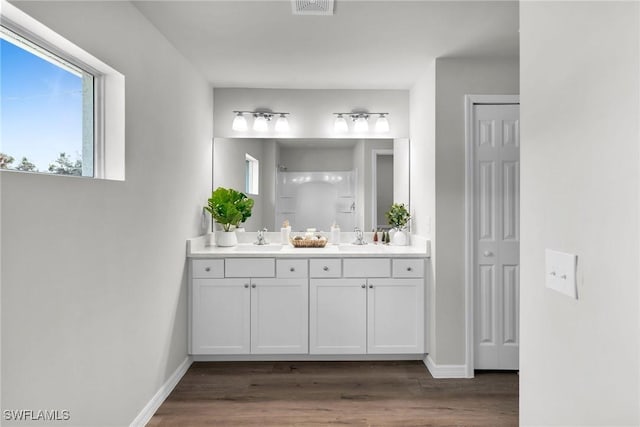 bathroom with vanity, a shower, and wood-type flooring