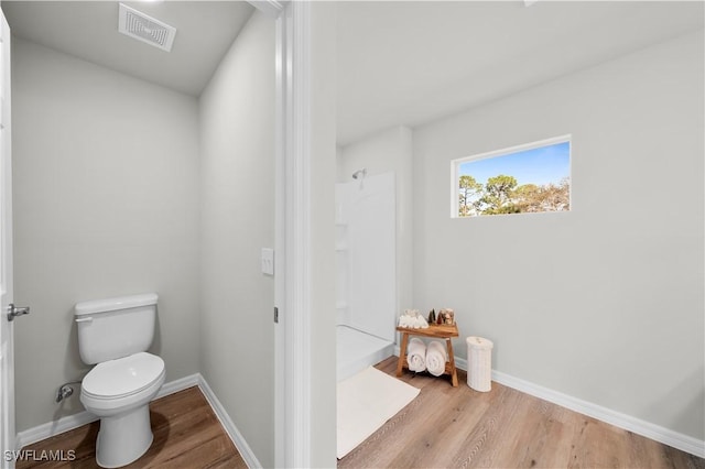 full bathroom with baseboards, visible vents, toilet, and wood finished floors