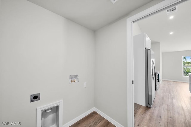 laundry room with hookup for a washing machine, visible vents, light wood-style floors, electric dryer hookup, and laundry area