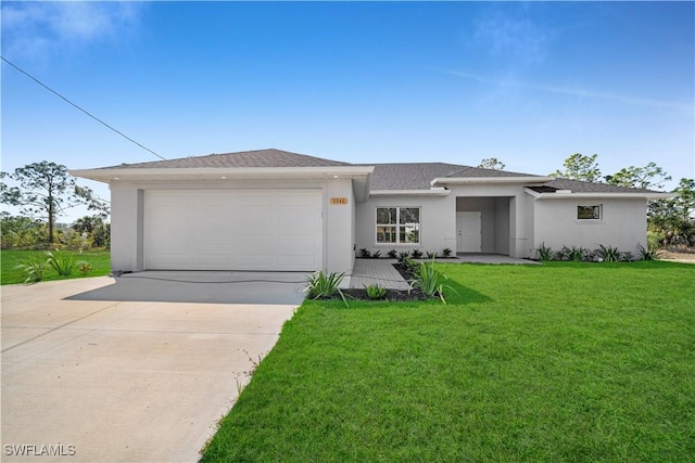 prairie-style home with a garage, concrete driveway, a front lawn, and stucco siding