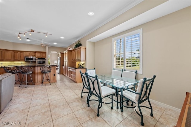 dining area featuring light tile patterned floors, ceiling fan, and ornamental molding