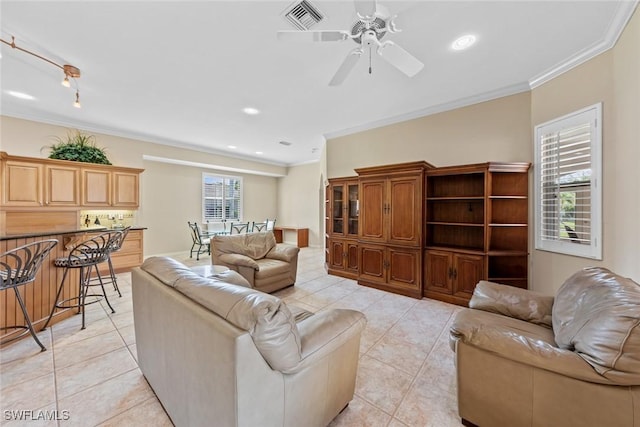 tiled living room featuring a wealth of natural light, crown molding, and ceiling fan