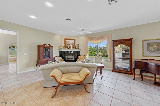 interior space with light tile patterned floors, ceiling fan, and ornamental molding