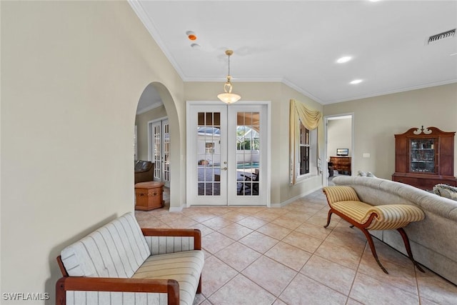 sitting room with light tile patterned floors, crown molding, and french doors