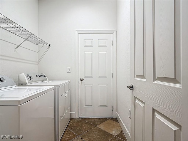 clothes washing area with washer and clothes dryer