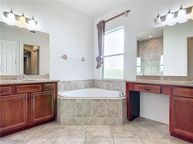 bathroom with vanity and shower with separate bathtub