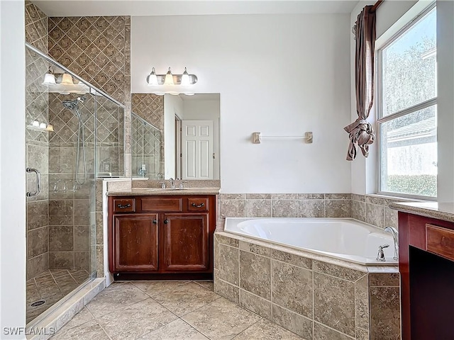 bathroom featuring tile patterned flooring, vanity, and shower with separate bathtub