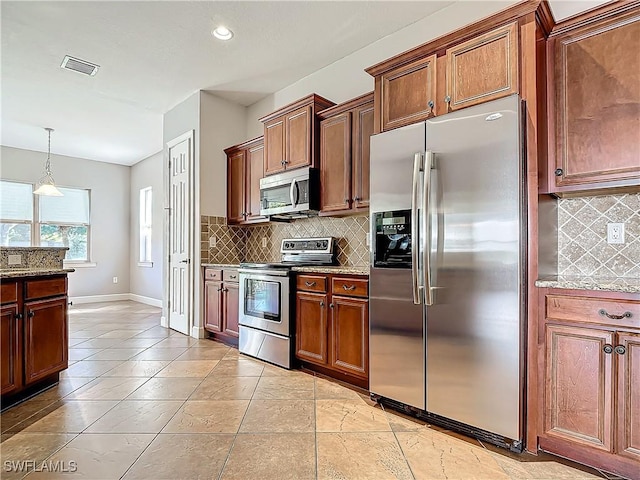 kitchen with light stone countertops, appliances with stainless steel finishes, decorative backsplash, and decorative light fixtures