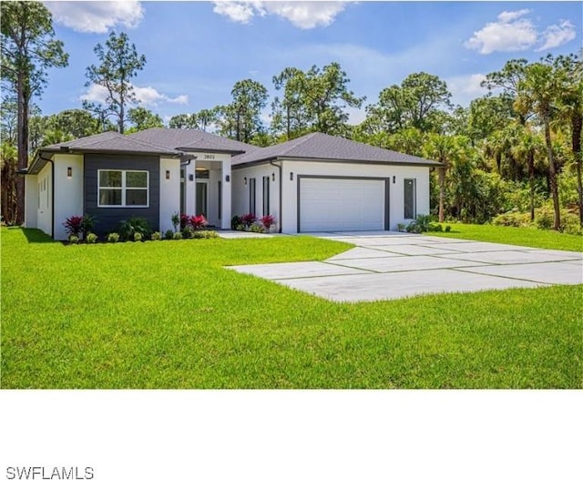 view of front of house featuring a front yard and a garage