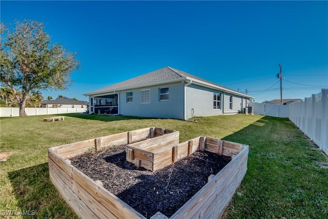 rear view of house with a sunroom and a lawn