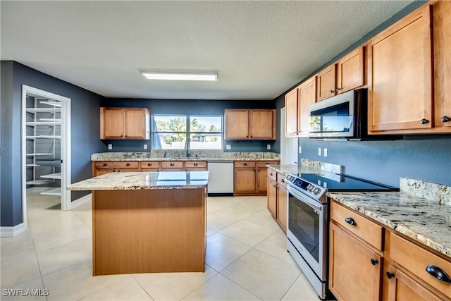 kitchen with stainless steel electric range, light stone countertops, a textured ceiling, dishwashing machine, and a kitchen island