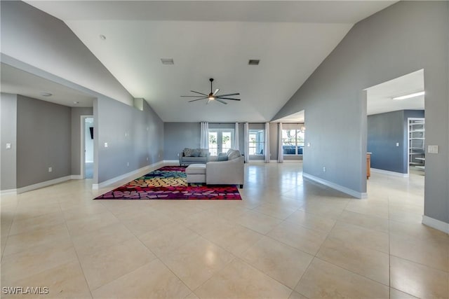 tiled living room with high vaulted ceiling and ceiling fan