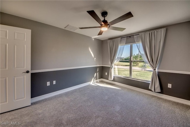 spare room with ceiling fan and carpet floors