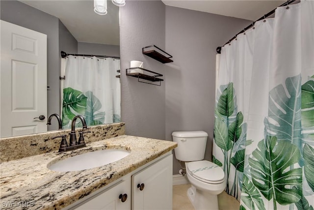 bathroom featuring tile patterned floors, vanity, and toilet