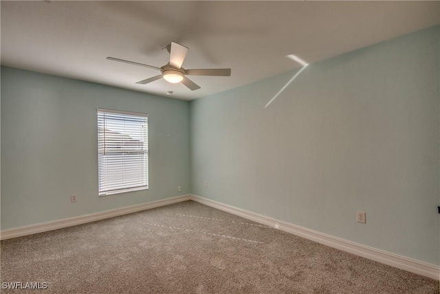 carpeted empty room featuring ceiling fan