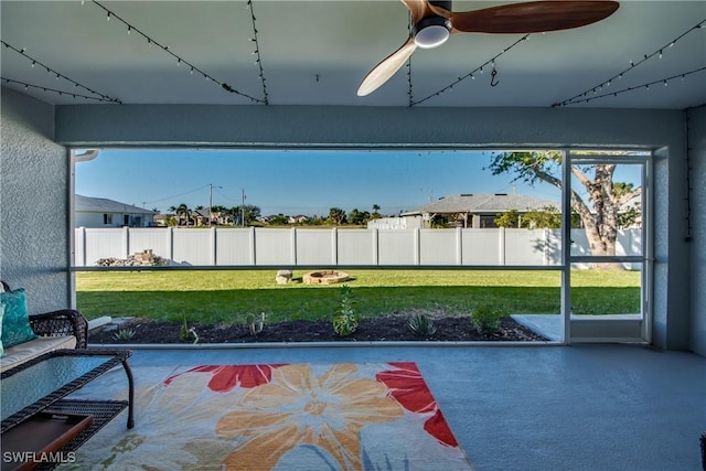 unfurnished sunroom featuring ceiling fan