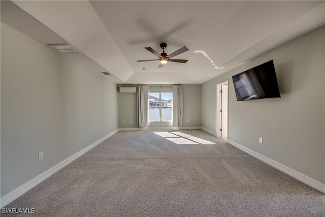 empty room with light carpet, an AC wall unit, and ceiling fan