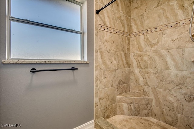 bathroom featuring tiled shower