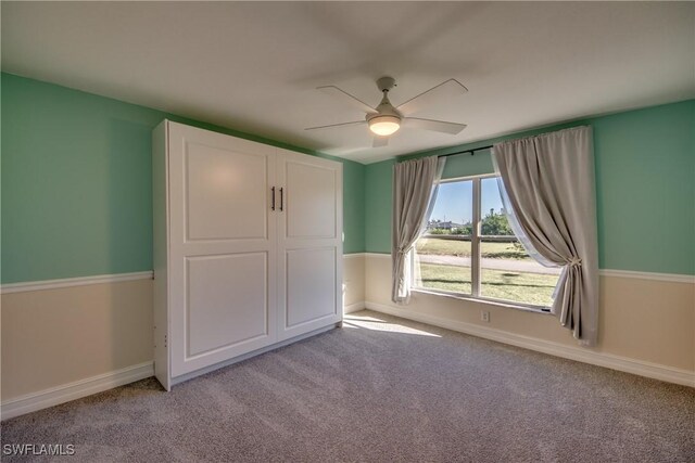 unfurnished bedroom with ceiling fan and light carpet