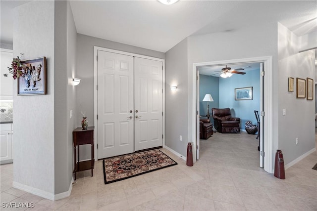 foyer entrance with ceiling fan