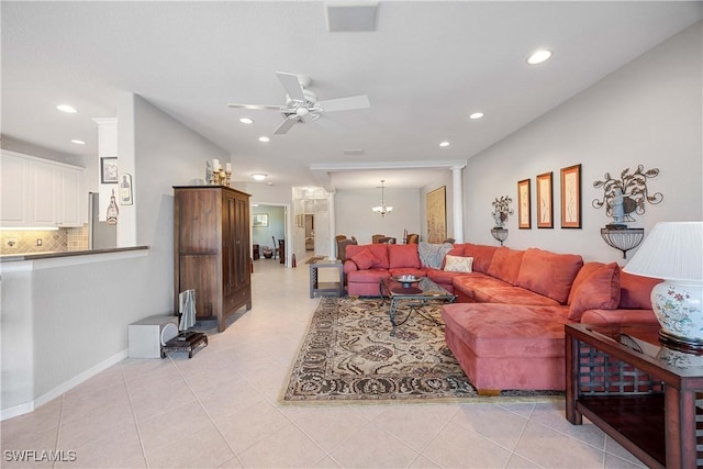 living room with ceiling fan with notable chandelier and light tile patterned flooring