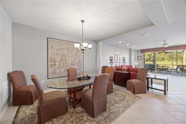 tiled dining area with expansive windows and ceiling fan with notable chandelier