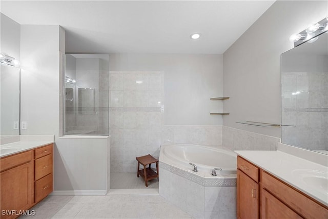 bathroom with tile patterned flooring, vanity, and independent shower and bath