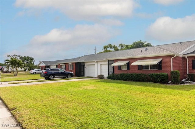 ranch-style home with a front lawn and a garage